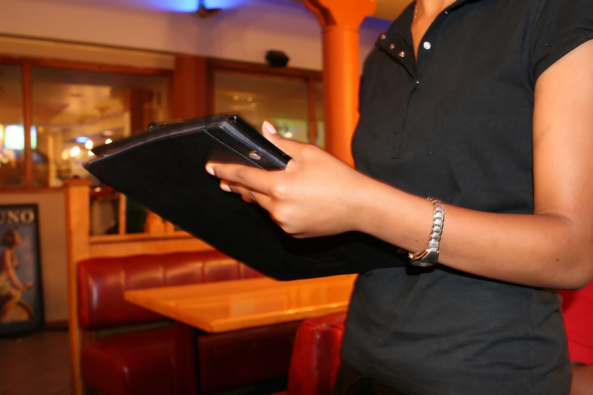 woman holding tablet in restaurant