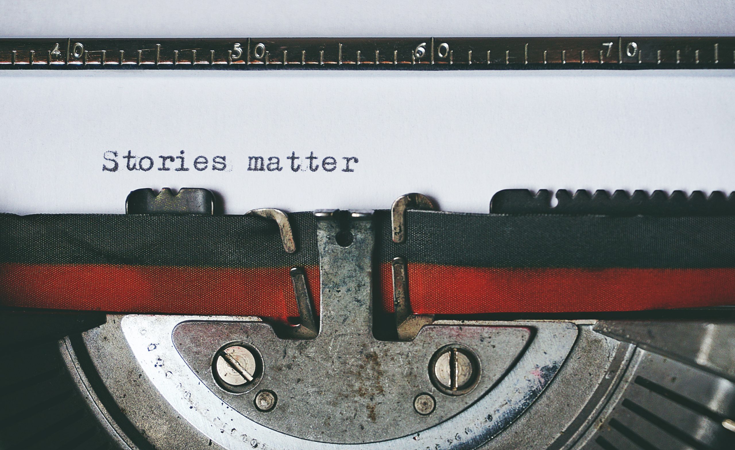 typewriter with words "stories matter"